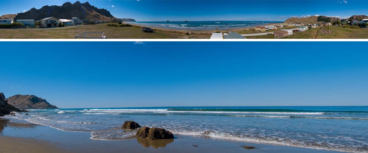 Kairakau beach with luxury holiday houses at the waterfront. The wavy sea is coming in along the rocky coastline